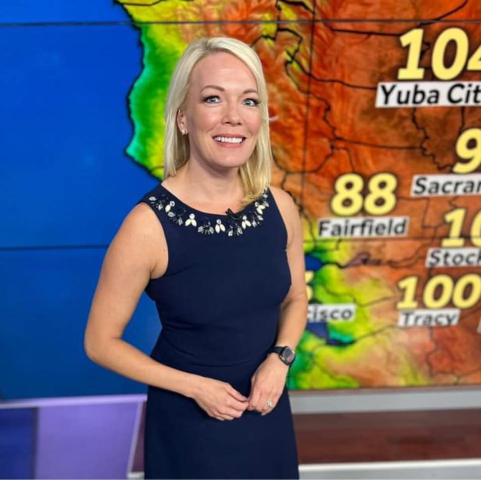 Tamara Berg, a meteorologist for KCRA 3, standing in front of a weather map on set.